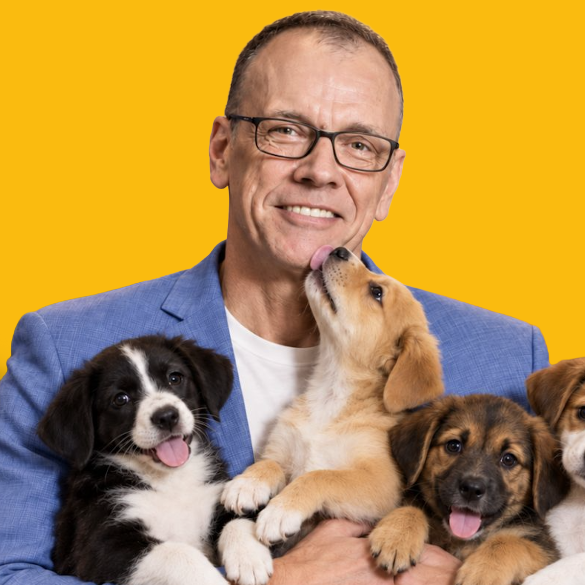 Michael Puck with a litter of puppies